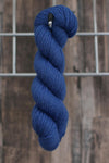 a single skein of blue wool hanging from a hook