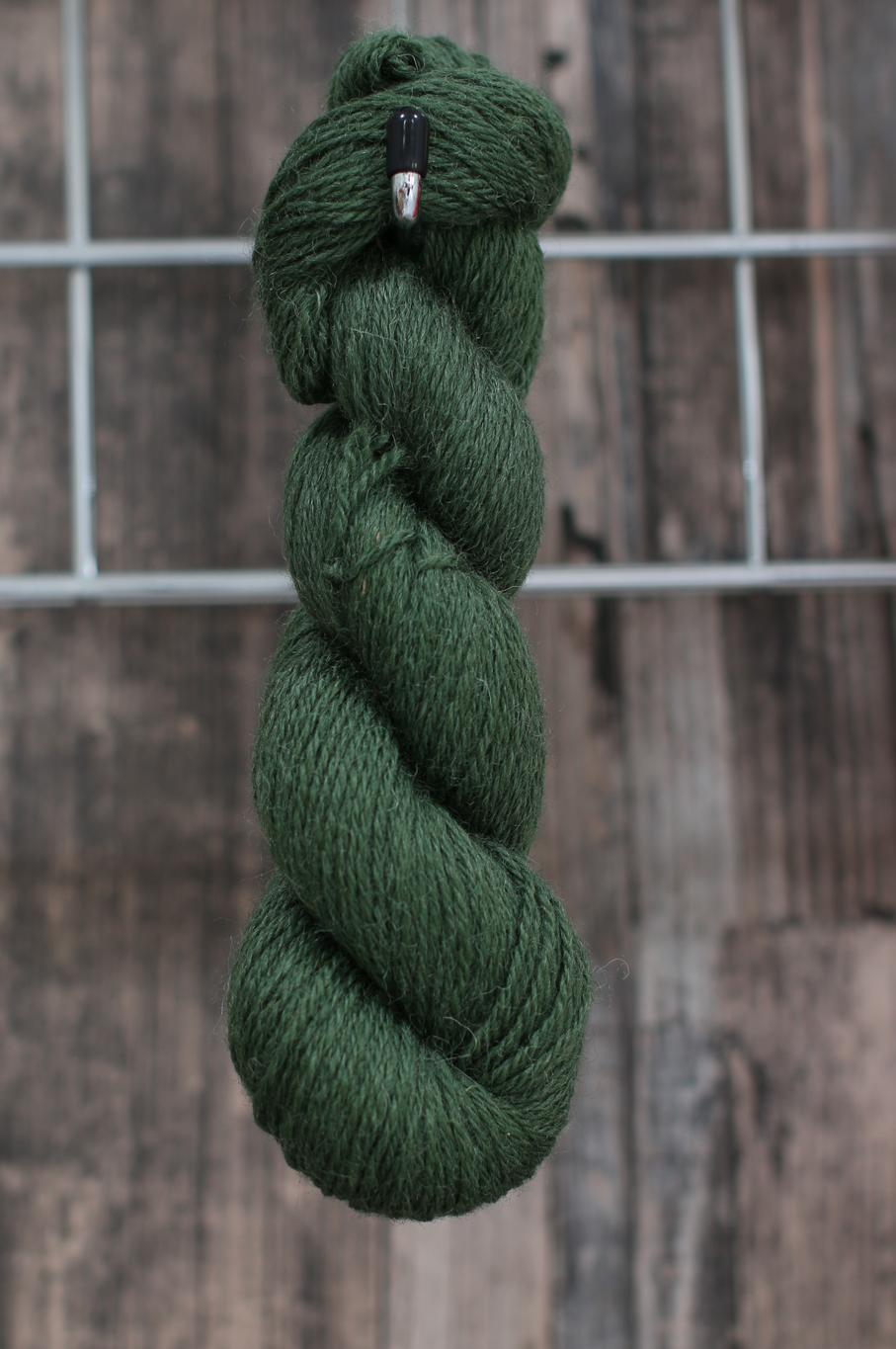A green skein of wool hanging from a hook